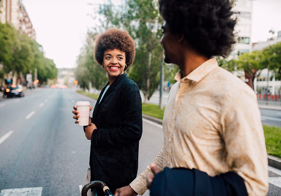 Young African - American couple go to work together.