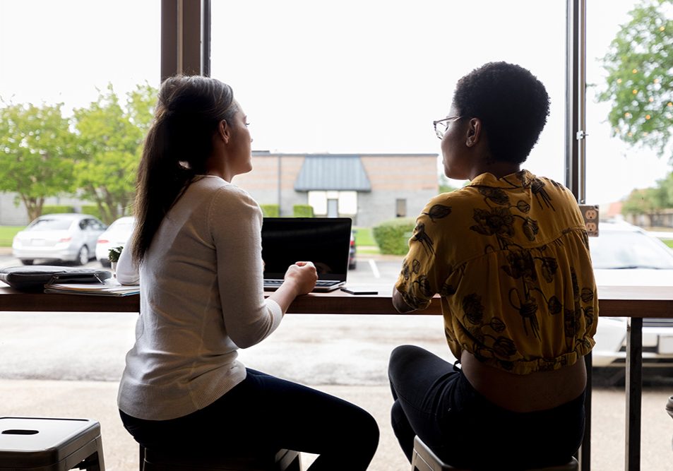 Female friends or business colleagues meet in coffee shop before or after work.