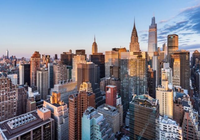 This high angle sunrise view from UN Plaza on the east side of Manhattan looks southwest over the Kips Bay neighborhood toward the Empire State Building, the Chrysler Building, and One Vanderbilt with Lower Manhattan and One World Trade Center in the distance.